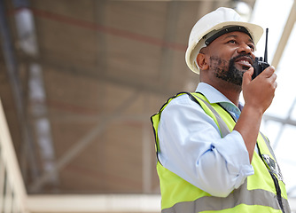 Image showing Walkie talkie, black man and engineer planning, communication and construction. African architect, radio and happy contractor with industrial project, building maintenance and engineering discussion.