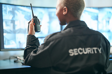Image showing Back, security and radio surveillance with a woman officer in a control to monitor criminal activity. Safety, dispatch and cctv with a female guard sitting in her office using a walkie talkie