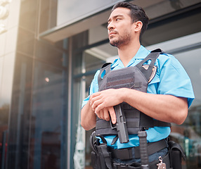 Image showing Security guard, safety officer and bodyguard man with a gun outdoor to patrol, safeguard and watch. Serious asian male at a building or property for crime prevention or armed response with a weapon