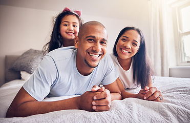 Image showing Family, relax and happy portrait on a bed at home while happy and playing for quality time. Man, woman or hispanic parents and a girl kid together in bedroom for morning bonding with love and care