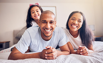 Image showing Portrait, happy and a family relax on a bed at home while laughing and playing for quality time. Man, woman or hispanic parents and kid together in the bedroom for morning bonding with love and care