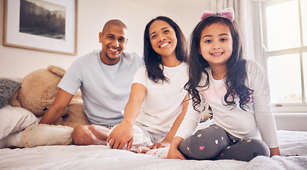 Image showing Family, relax and happy portrait on a bed at home with a smile and comfort for quality time. Man, woman or parents and a latino girl kid together in the bedroom for morning bonding with love and care