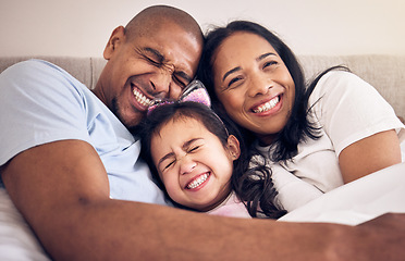 Image showing Family, hug and happy on a bed at home with a smile, comfort and security for quality time. Man, woman or latino parents and a girl kid together in the bedroom for morning bonding with love and care