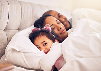 Image showing Family, portrait of a girl in bed with her parents and morning with adorable little child in the bedroom at home. Face, smile or happy with a young female kid in the house to relax with mom and dad