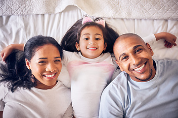Image showing Mother, father and portrait of a child on a bed in a family home with a smile and comfort for quality time. Above a man, woman and a girl kid together in the bedroom for morning bonding with love
