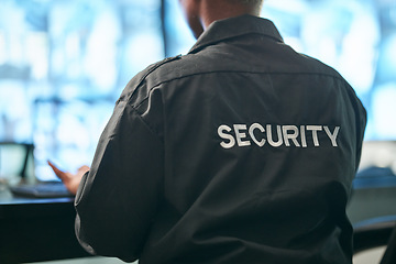 Image showing Office safety, back and man or security for a business or building for service. Law patrol, working and a worker at a professional job as a bodyguard or agent for protection at a workplace or agency