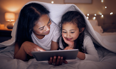 Image showing Mother, child and tablet with blanket at night in home for online games, reading ebook story and movies. Happy mom, girl kid and streaming cartoon on digital technology, media connection and bedroom