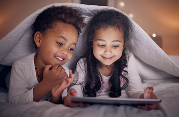 Image showing Happy, night and children with a tablet in bed for cartoon, movie or streaming a show. Smile, blanket and girl kids with technology in the bedroom for the internet, education or online fun together