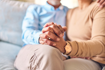 Image showing Love, support and a senior couple holding hands while sitting on a sofa in the living room of their home during retirement. Trust, relax or affection with an elderly man and woman bonding together