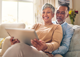 Image showing Happy, streaming and a couple with a tablet on the sofa for communication, social media or online chat. Smile, house and a senior man and woman with a movie on technology on the couch and laughing