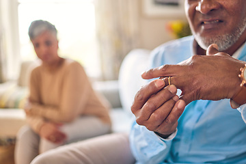 Image showing Senior man, hands and ring in divorce, fight or conflict from disagreement or argument on sofa at home. Elderly couple in depression, infertility or cheating, mistake and toxic marriage in the house