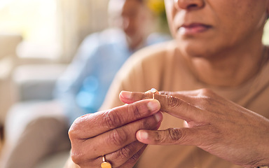 Image showing Senior couple, hands and ring in divorce, fight or conflict from disagreement or argument on sofa at home. Elderly man and woman in depression, infertility or cheating and toxic marriage in the house