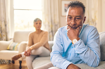 Image showing Couple fighting, stress and divorce with a senior man on a sofa in the living room of his home after an argument. Sad, anxiety or depression with an elderly male pensioner looking down after conflict