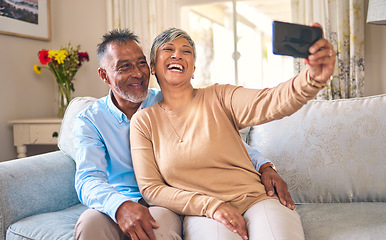 Image showing Senior couple, selfie and laughing at home for social media, network connection or memory. Mature man and woman together with smartphone for a profile picture with a smile and love on a lounge sofa