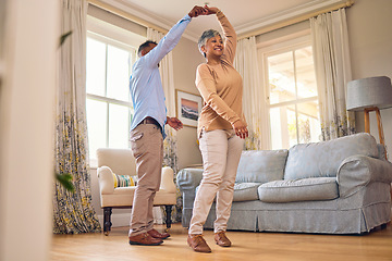 Image showing Retirement, romance and dance with a senior couple in the living room of their home together for bonding. Marriage, love or fun with an elderly man and woman dancing in the lounge of their house