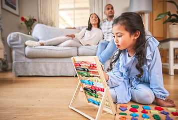 Image showing Child, family home and learning with abacus on the floor or mom, dad and girl relax in living room with a game. Kid, development in math and toys for education and couple together on couch in house