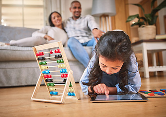 Image showing Child, toys for learning and tablet for education in family home with abacus on the floor with mom, dad in living room with a game. Girl, development in math and couple together on couch in house