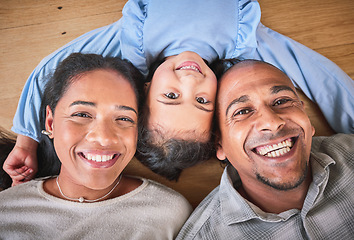 Image showing Face, family and smile in home top view, bonding and having fun on floor in house. Portrait, parents and happy child, mother and father with love, relax on ground and enjoying quality time together.