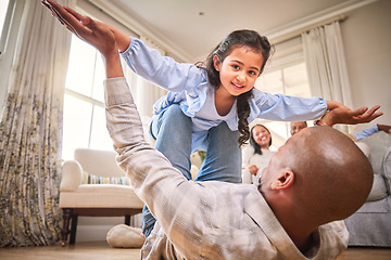 Image showing Family, fun and a daughter flying with dad on the floor of a living room in their home together for bonding. Smile, children and portrait a happy girl playing fantasy games her father in their house