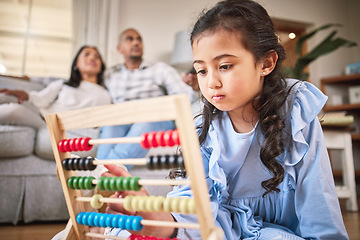 Image showing Child, toys for learning and education in family home with abacus on the floor or mom, dad and girl relax in living room with a game. Kid, development in math and couple together on couch in house