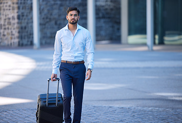 Image showing Portrait, travel and a businessman with a suitcase in the city for a holiday or work trip in Singapore. Serious, worker and a male employee with luggage in town for a corporate journey or vacation