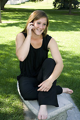 Image showing Beautiful Girl in the Park in a Black Dress Talking on the Phone