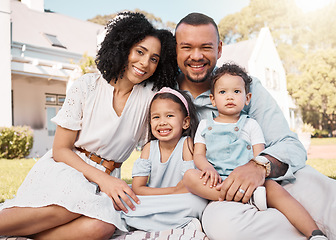 Image showing Portrait, blended family and parents on the lawn with their children in the garden of their home together. Mother, father and kids sitting on the grass in the yard of their house for love or bonding