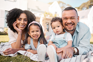 Image showing Portrait, blended family and parents on the lawn with their kids in the garden of their home together. Mother, father and children lying on the grass in the yard of their house for love or bonding