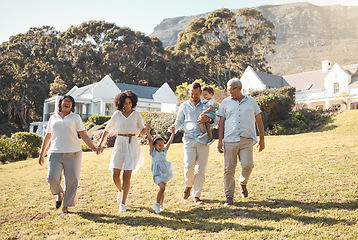 Image showing Holding hands, kids and a blended family walking in the garden of their home together during summer. Grandparents, parents and children on grass in the backyard of a house for bonding during a visit