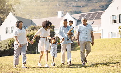 Image showing Holding hands, children and a blended family walking in the garden of their home together during summer. Grandparents, parents and kids on grass in the backyard of a house for bonding during a visit