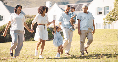 Image showing Holding hands, children and a blended family walking in the backyard of their home together during summer. Grandparents, parents and kids on grass in the garden of a house for bonding during a visit