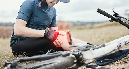 Image showing Injury, accident and a man with knee pain and a bike in nature after cycling or travel for fitness. Sports, cardio inflammation and a biker with a medical emergency on a bicycle in the countryside