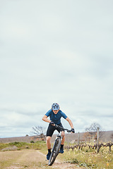 Image showing Exercise, man and cycling for fitness, bike and training with wellness, helmet for safety and health. Male person, athlete or cyclist with action, race and adrenaline junkie with adventure and travel