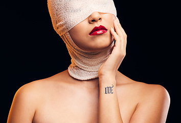 Image showing Bandage, plastic surgery and a woman with cosmetics on a dark background for a medical procedure. Beauty, healing and a girl or model after botox or facial change isolated on a studio backdrop