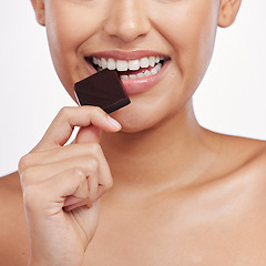 Image showing Chocolate, bite and mouth of woman in studio eating luxury food, sweet treats and candy. Sugar, calories and face closeup of female person with cocoa, dessert and snack isolated on white background