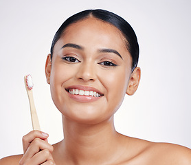 Image showing Portrait, smile and woman with a toothbrush, self care and dental hygiene against a white studio background. Face, female person or model with oral hygiene, toothpaste or cleaning mouth with wellness