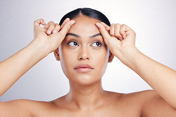 Image showing Face, beauty and eyebrows with a model woman in studio on a gray background for skincare or cosmetics. Facial, makeup and eyes with a young female person touching her skin after facelift treatment