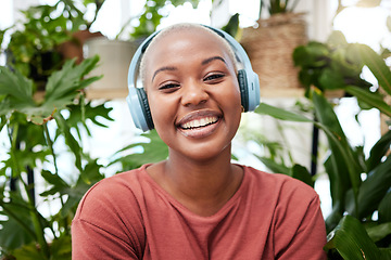 Image showing Relax, music and portrait of black woman with plants in home for wellness, happiness and calm. Nature, headphones and face of female person listening to audio with ferns, leaves and house plant