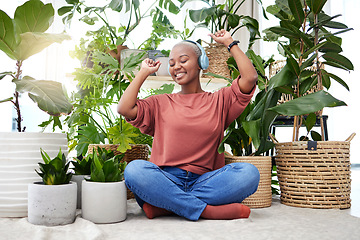 Image showing Music, dance and radio with a black woman in her home by plants while streaming an audio playlist. Freedom, headphones and subscription service with a carefree young female person in her house