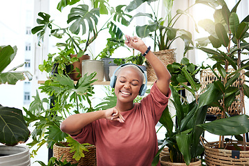 Image showing Music, dance and headphones with a black woman in her home by plants while streaming an audio playlist. Freedom, radio and subscription service with a happy young female person eyes closed in a house