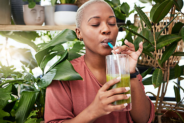 Image showing Nutrition, drinking and black girl with green smoothie for diet with plants for wellness or weightloss. Healthy, woman and enjoy a detox drink with vegetables for vitamins with supplement in home.