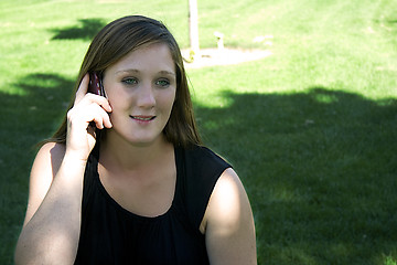 Image showing Beautiful Girl in the Park in a Black Dress Talking on the Phone