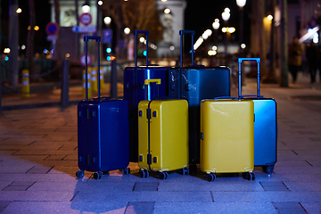 Image showing Luggage consisting of six polycarbonate suitcases standing on the street