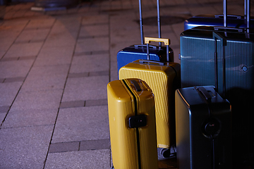 Image showing Luggage consisting of six polycarbonate suitcases standing on the street