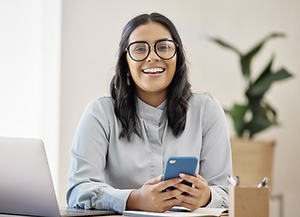 Image showing Technology, portrait of happy businesswoman with smartphone and at her desk in a modern office. Online communication or digital connectivity, internet researching and cheerful woman with cellphone