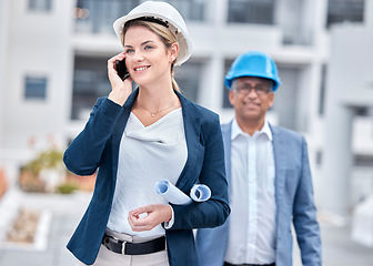 Image showing Architect woman, phone call and walking in city, networking and chat with partner, blueprint or negotiation. Architecture team, diversity and smartphone with paperwork, listening and outdoor in metro