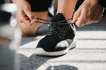 Image showing Exercise, shoes and tie laces with a man in a sports gym getting ready for a cardio or endurance workout. Fitness, running and preparation with a male athlete or runner at the start of training