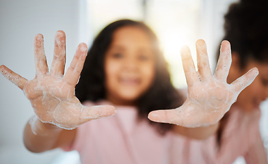 Image showing Girl kid, washing hands and palm in closeup with foam, cleaning and learning hygiene in family home. Young child, soap and mother for bacteria, germs and stop virus for care, bond and love in house