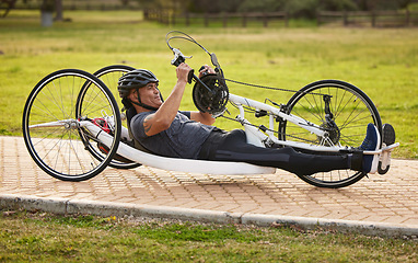 Image showing Cycling, sports and fitness with man and handcycle on road for training, bike and challenge. Exercise, workout and marathon with person with a disability riding in park for cardio and health