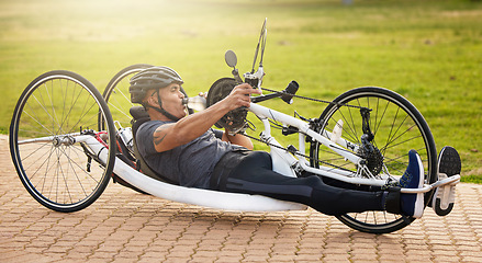 Image showing Fitness, cycling and a man with a disability and on a bike for training, travel and exercise in nature. Sports, street and a person in a wheelchair bicycle for a workout, health or cardio in a park